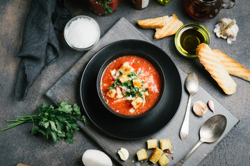 Traditional spanish gazpacho made from fresh farm produce on a dark background. top view