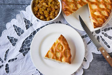 Homemade pie with cottage cheese and raisins in a rustic style.