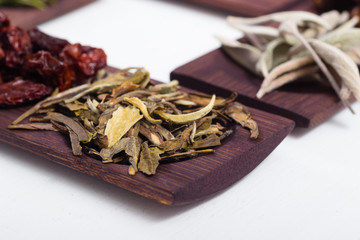dried fruits and spices on wooden tray, white table