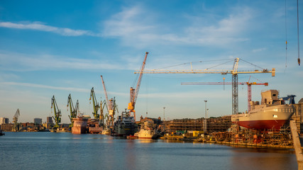Obraz premium View of the shipyard with historical cranes and ships in the industrial part of the city Gdansk/Poland.