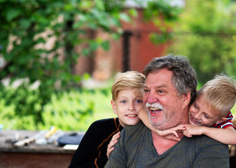 Portrait of a middle-aged Caucasian gray-haired man with a grandsons