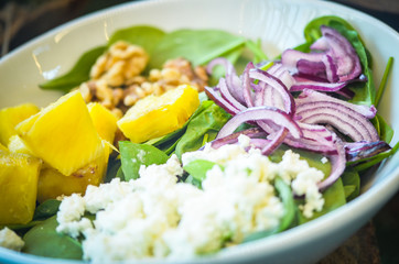 different mix salad - fresh food, vegetables, proteins, fruits, dressing, nuts