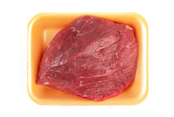 Raw meat with plastic tray isolated on white background. Top view. Flat lay.