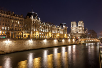 Fototapeta na wymiar Notre Dame Cathedral and the Seine river in Paris at night, France.