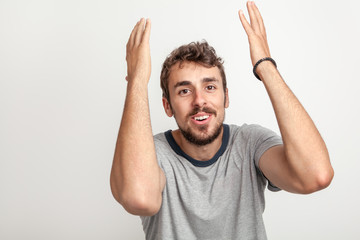 Smiling happy man gesticulating with raised hands