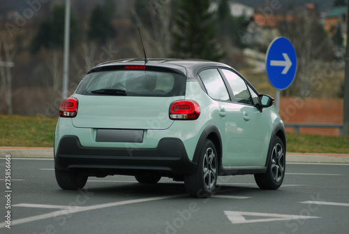 car going at high speed cornering, rear view