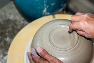 hands of a potter, creating an bowl on the circle, Pottery polishing process with 2 hands in the final step. Before entering the kiln.