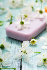 Obraz na płótnie Canvas soaps with cherry flowers on old blue wood table