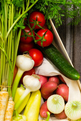 vegetables and a loaf of bread at wooden crate, top view