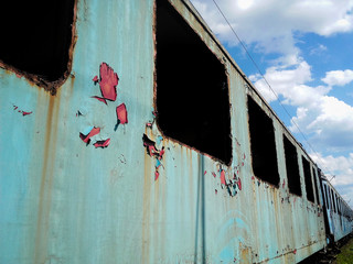 Old train abandoned  in a  train station agains blue sky