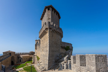 Fototapeta na wymiar The ancient fortress on the top of the cliff in San Marino.