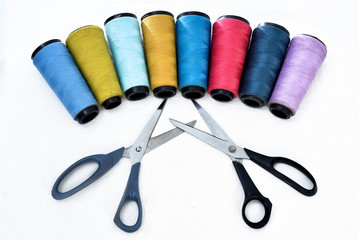 Traduzir do: Inglês 60/5000 Colorful sewing thread reels on white background with scissors