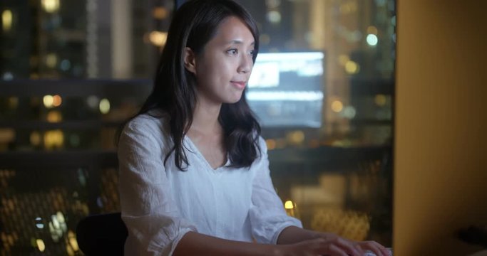 Woman work on computer at office over time