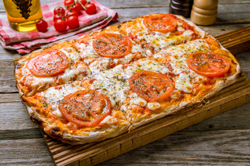 margarita pizza at the Rome dough on wooden background