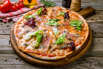 Pizza with Parma ham on the board