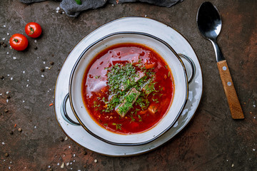 Borscht with sour cream on rustic background