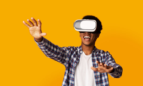 African-American Guy Using VR Headset, Yellow Background