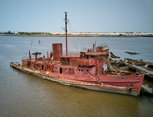 Aerial drone image of Sunken and rotting Wood ships and rotting hulls and rusting  Iron ships with...