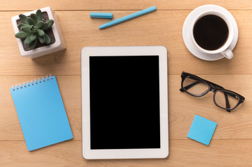 Tablet with black blank screen on office table