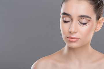 Fototapeta premium Young woman with clean healthy skin posing with closed eyes