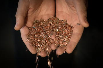 Copper shavings in the hands of the workers.