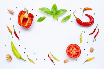 Various fresh vegetables and herbs on white background.