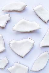 Coconut pieces on white background.