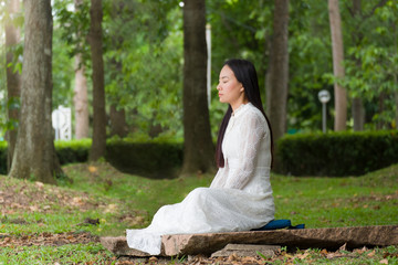 Beauty woman meditating in the garden.