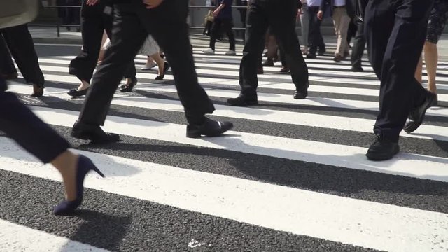 横断歩道を渡るビジネスマンの後ろ姿　スローモーション