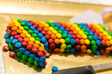 Birthday cake covered colourful candies 