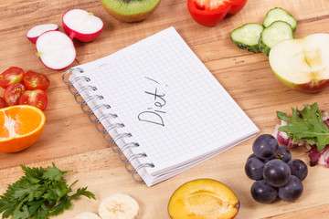 Fruits and vegetables containing minerals and notepad with inscription diet, healthy nutrition...