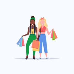 mix race women holding colorful paper bags couple girls carrying purchases big sale shopping concept flat full length