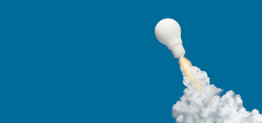 Ideas inspiration concepts with rocket lightbulb on blue background.Business start up or goal to success