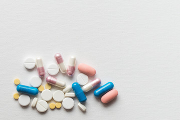 Medicine pills or capsules on white background, copy space. Pharmaceutical medicament for health. Antibiotic