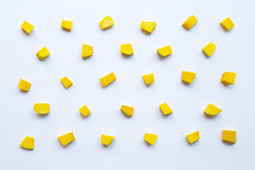 Green pumpkin vegetable cube slices isolated on white background.