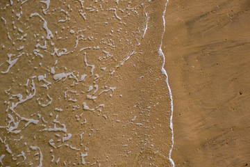 Small waves onto sandy beach from above