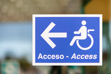 A sign on a glass screen in the entrance area at a hospital in Spain. Disabled people and...