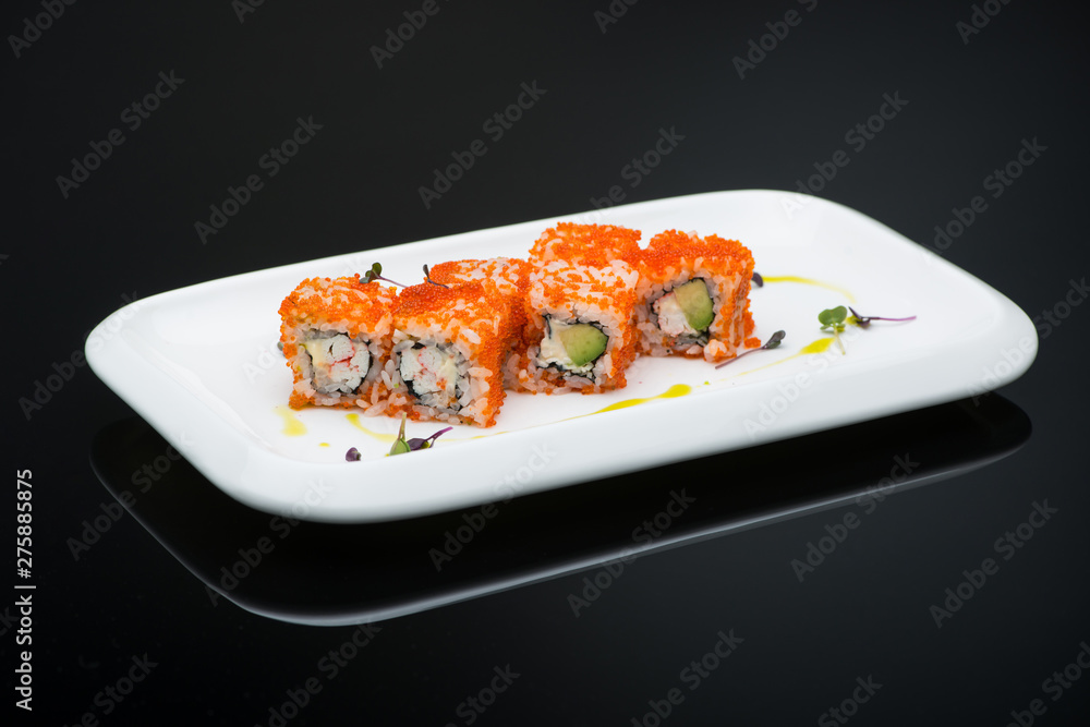 Wall mural sushi in a plate on a black background with reflection. fish roll