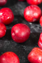 Red plum. Dark background. Healthy diet