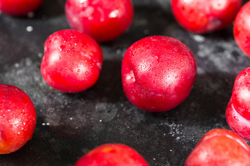 Red plum. Dark background. Healthy diet
