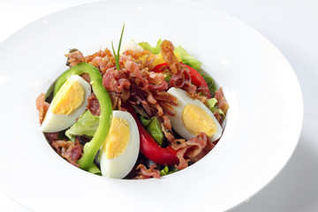 Fresh Caesar Salad with Deep-fried Bacon and Boiled Egg on White Porcelain Round  Dish, Isolated on White Background with Shadow. Close Up High Angle Top View, Selective Focus at Food.
