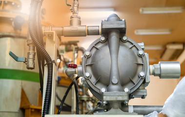 Air pressure pump installed for transferring chemicals in industrial factory.
