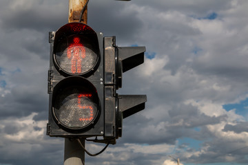 Red light at traffic lights for pedestrians. 5 seconds left.