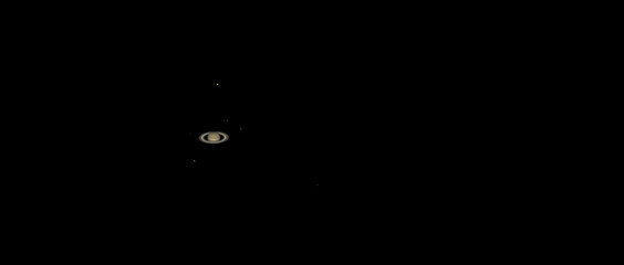 Giant ring planet Saturn with its six moons Titan, Rhea, Tethys, Dione, Iapetus, Enceladus, photographed on June 29, 2019 with a small refractor telescope from Mannheim in Germany.