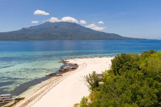 White sandy beach on the island of Mantigue, Philippines. View of the island Camiguin. White sand beach and boats.