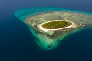 Mantigue Island, Philippines. Tropical island with white sandy beach and coral reefs. Seascape, view from above.