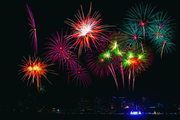 Beautiful colorful fireworks display on the sea beach, Amazing holiday fireworks party or any celebration event in the dark sky.