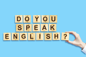 Do you speak English The inscription on the wood blocks,isolated, blue background. Concept for...