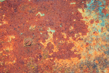 Old grungy cracked blue weathered wall paint peeling off rusted metal sheet. Textured background...