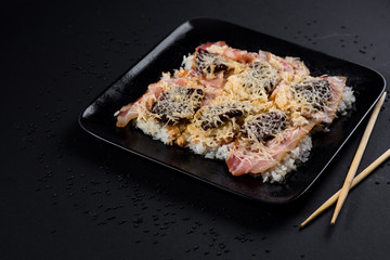 Sushi pizza on black